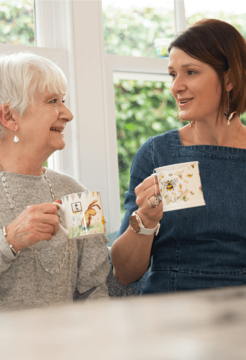 Mum and Daughter together in kitchen, having a tea and chat.